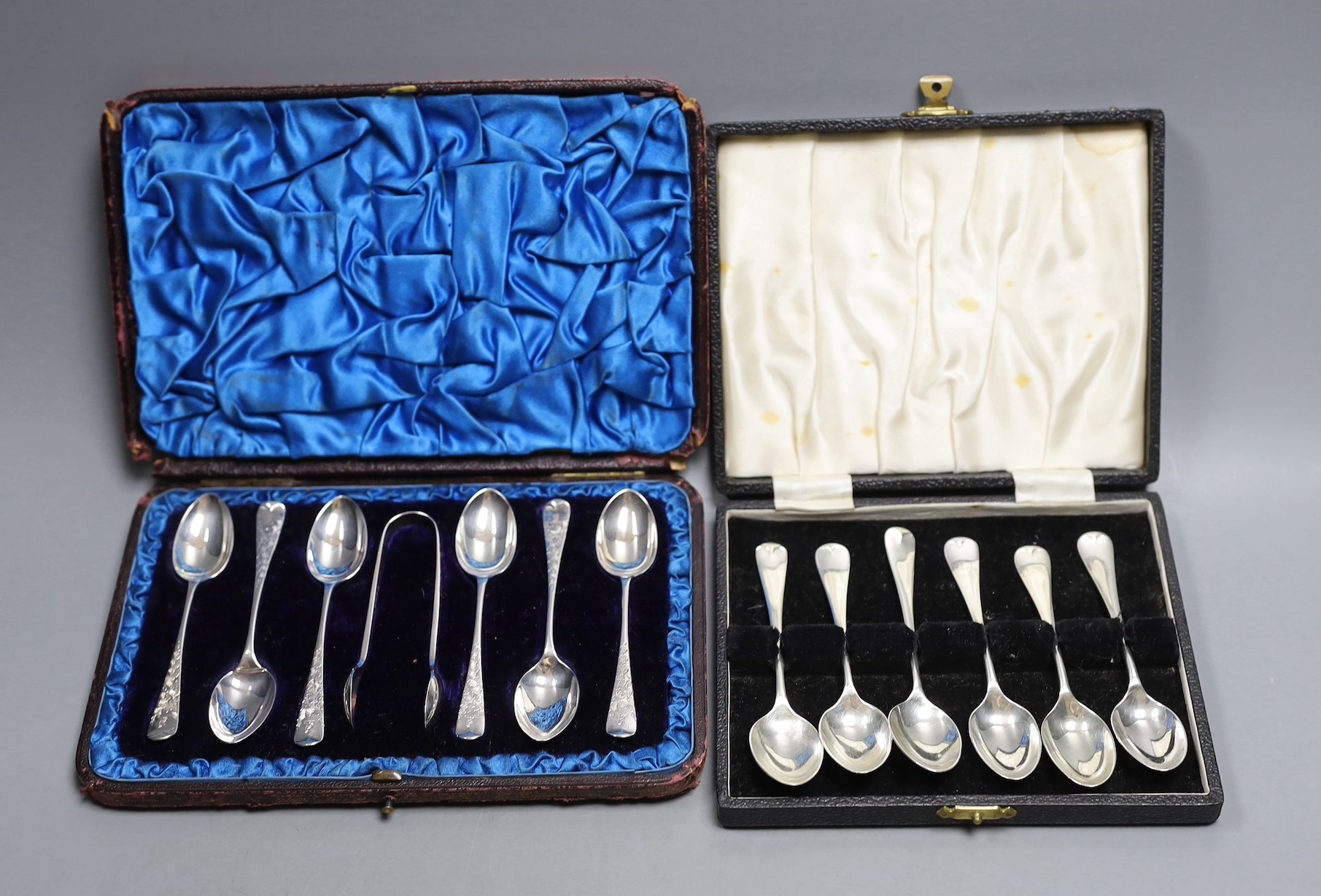 Two cased sets of six silver coffee spoons, including A Victorian set with sugar tongs, the other modern set with picture back bowls.